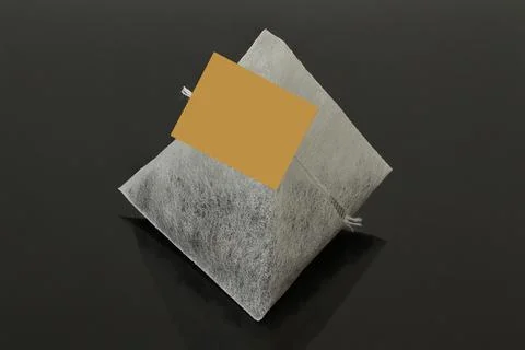 Triangular tea bag on a black background. 스톡 사진