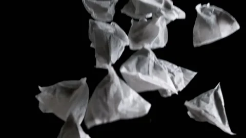 Triangular tea bags up in the air against a black background Stock Footage 182768583