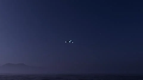 A triangular UFO flies over the ocean on a starry night. 3d render Stock Footage 296007445