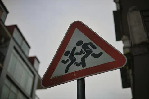 Triangular Warning Sign for Children Crossing Near School Zone Stock Photos
