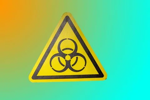 A triangular warning sign displays the radiation symbol. The bright yellow co Stock Photos