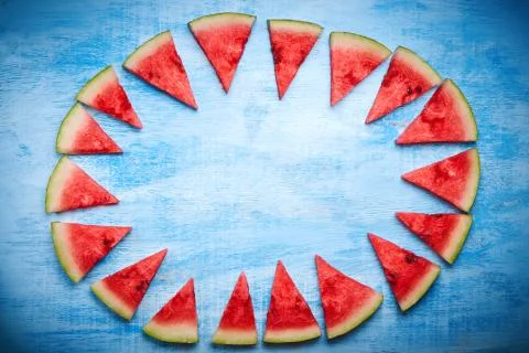 Triangular Watermelon slices on blue background. Top view, flat lay. 스톡 사진