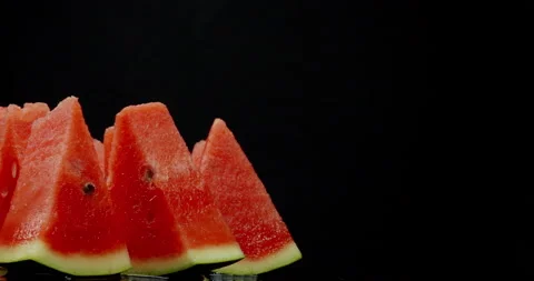 Triangular watermelon slices slowly rotate in front of the camera 스톡 동영상 239058921
