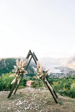 Triangular wedding arch wigwam stands on a mountain above the Bay of Kotor Stock Photos