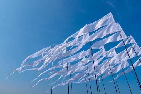 Triangular white banner against the blue sky. Triangular white banner agai... 스톡 사진
