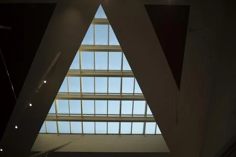 Triangular window in building. Architecture details. Glass in roof. Stock Photos
