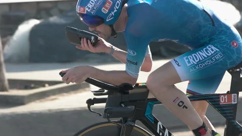 Triathlete drinking water while racing at IRONMAN 70.3 Vietnam in Danang in M Video stock 156317497