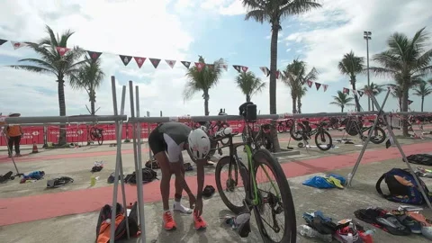 Triathlete heading out of the transition technical area to the run course at  Stock Footage 156674465