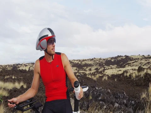 Triathlete resting drinking water from taking workout break - Triathlon cycling Stock Footage 75624648