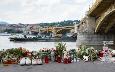 Tributes including flowers, candles and pairs of shoes placed by the Danube Stock Photos