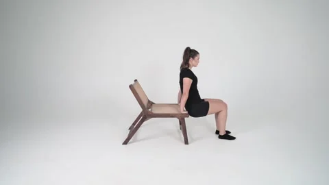 Tricep dips on edge of chair Stock Footage 314196014