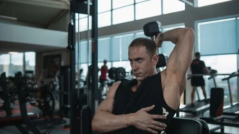 Triceps workout with dumbbell. Loop Stock Footage 82355535