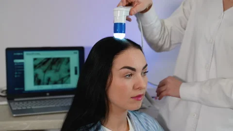 Trichologist performing scalp analysis with digital device Stock-Footage 303451402