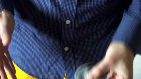 The trick with the hand spinner on a black background,the young man throws the Stock Footage 76782993