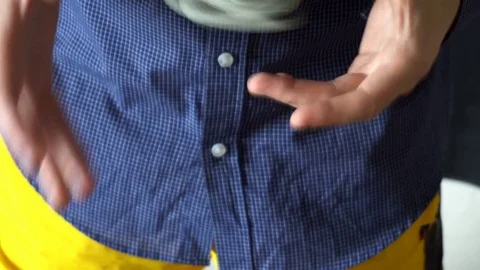 The trick with the hand spinner on a black background,the young man throws the Stock Footage 76783142