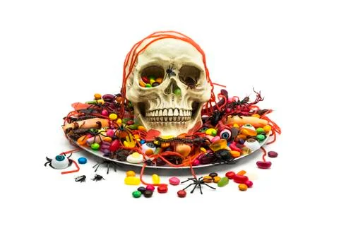 Trick or treat candy and skull in a candy dish Stock Photos