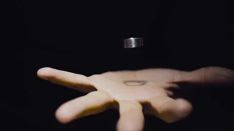 The trick with the ring. Levitation ring in the hand of the magician. Ring hangs Stock Footage