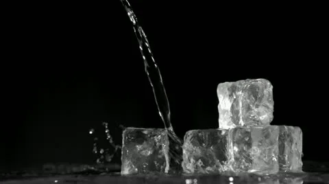 Trickle of water in super slow motion flowing on ice cubes Stock Footage 10866351