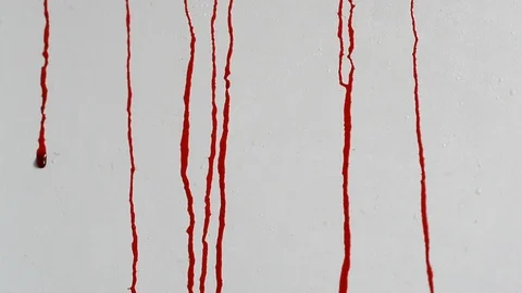 Trickles of blood flow down the white wall close-up Stock Footage 114893820