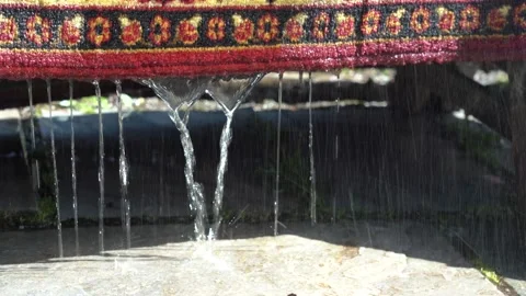 Trickles of Water Flow Down From the Washed Woolen Carpet. Close-up 스톡 동영상 150864861