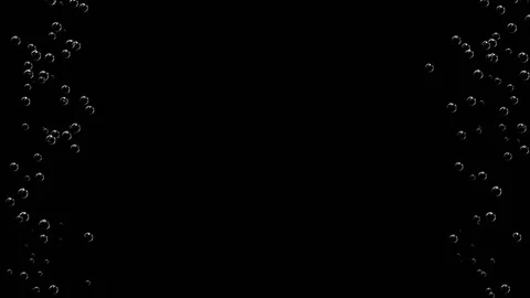 Trickles of white bubbles rise up different sides of the black screen. Stock Footage 151813448