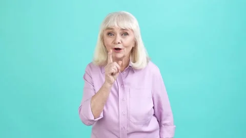 Tricky aged lady ask not share be silent isolated cyan color background Stock Footage 196146800