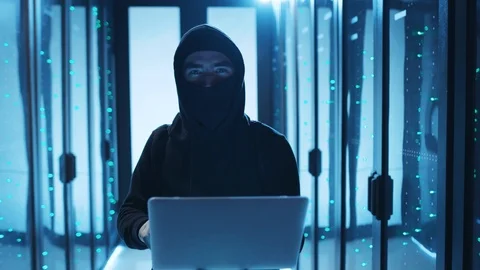 Tricky computer hacker breaking a server supercomputer, turning off lights by Stock Footage 120695819