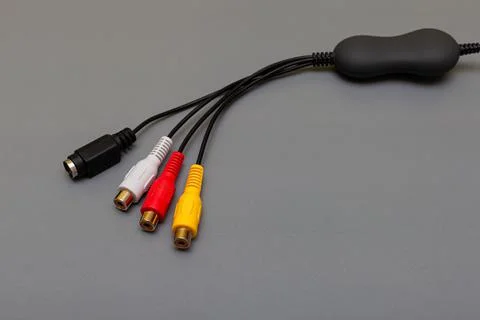 Tricolor composite cable with decoder on gray background Stock Photos