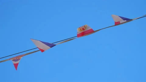 Tricolore banner flags hanging on cable in French city Stockbeeldmateriaal 220038276