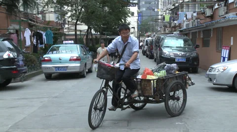 Tricycle pulling out of side road Stock Footage 37696095