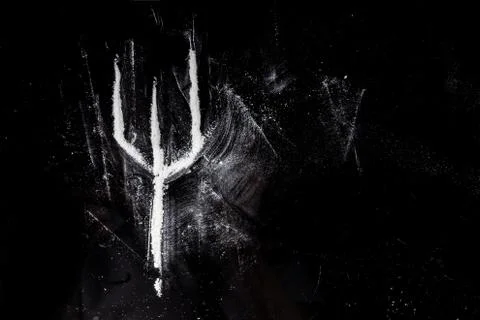 The trident inscribed from cocaine, the sign of the devil. Stock Photos
