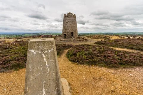 Trig post and derelict stone windmill, Parys Mountain. Stock Photos