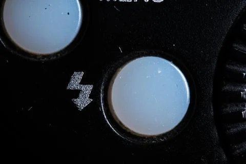 The trigger flash icon button is close on the flash for camera device. Old .. Stock Photos
