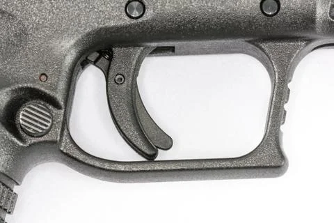 Trigger of hand gun on white background Stock Photos