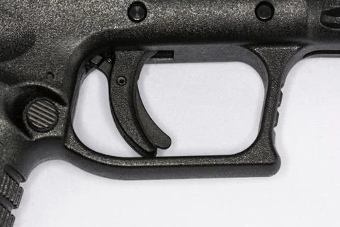 Trigger of hand gun on white background Stock Photos