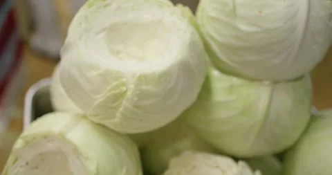 Trimmed white cabbage heads stacked close together, Food Factory Stock Footage 340045331