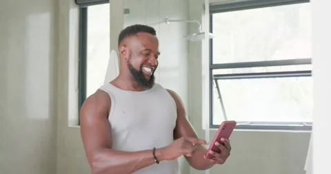 Trimmer buzzing as man is trimming beard, checking phone, brushing teeth, Stock Footage 341736756
