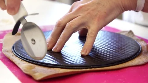 Trimming dough for making a round cake Stock Footage 83733049
