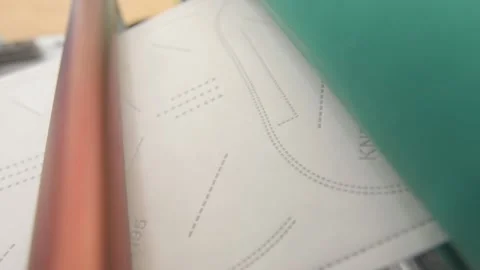 Trimming the shape of the protective masks from the Roll of Cloth. Close-up Stock Footage 138521375
