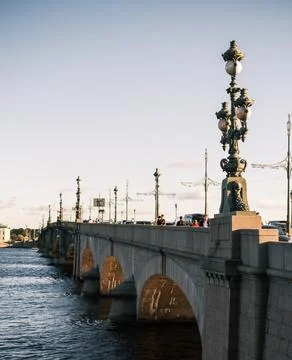 Trinity Bridge drawbridge across the Neva River at sunset. Object of cultural Stock Photos
