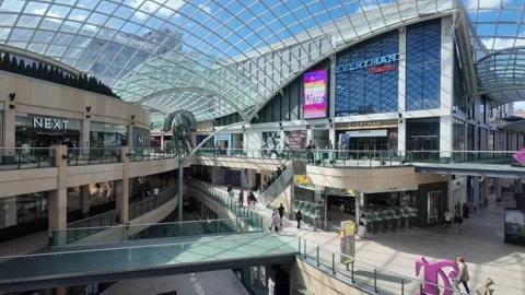 Trinity Leeds - Pedestrians walking through modern indoor shopping mall. Video stock 338218251