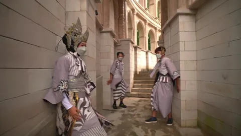 Trio of Dancers Performing Rhythmic Hand Movements in Stone Hallway Stock Footage 276349216