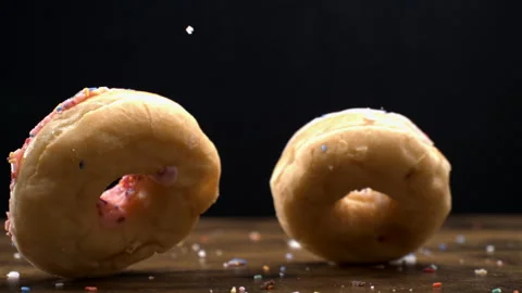 Trio of Donuts Falling onto Table in Slow-Motion, Captured at 800 fps on Bl.. Stock Footage 273370167