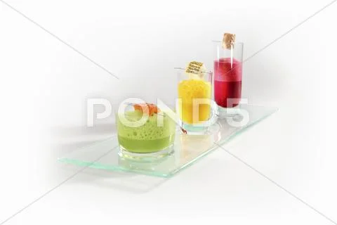 A trio of foam soups with corresponding fish Stock Photos