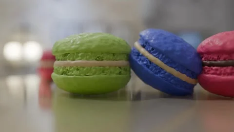 Trio of Macaron Delights: Close-Up on Green, Blue &amp; Pink French Pastries, Gourme Stock Footage 307348564