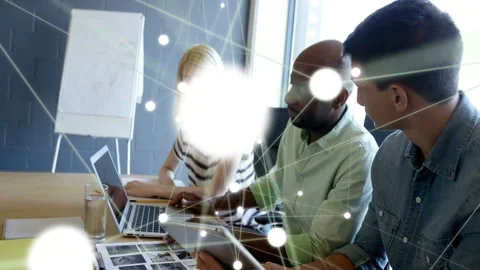 Trio tapping devices during design review, sparking node overlay flaring over Stock Footage 333169502