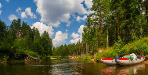 A trip on a catamaran through the quiet forest river on beautiful sunny summe Stock Photos
