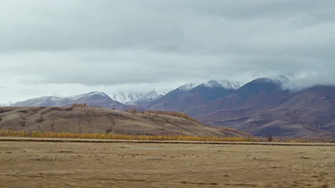 Trip through steppe surrounded by ridge in autumn Video stock 232237842