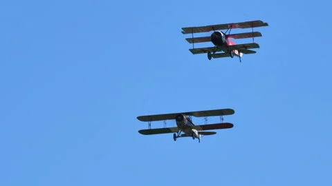 Triplane and bi-plane pass across the sky Video stock 196727279