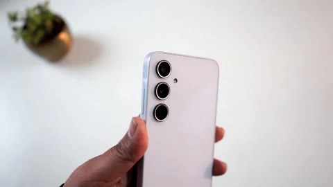 Triple camera lens module of Samsung Galaxy A35 smartphone Stock Footage 327194338